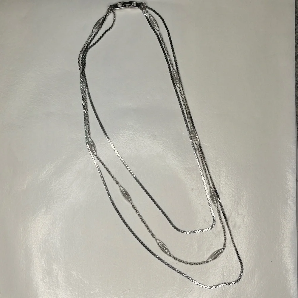 Napier 3 strand silver graduating length chain necklace.
